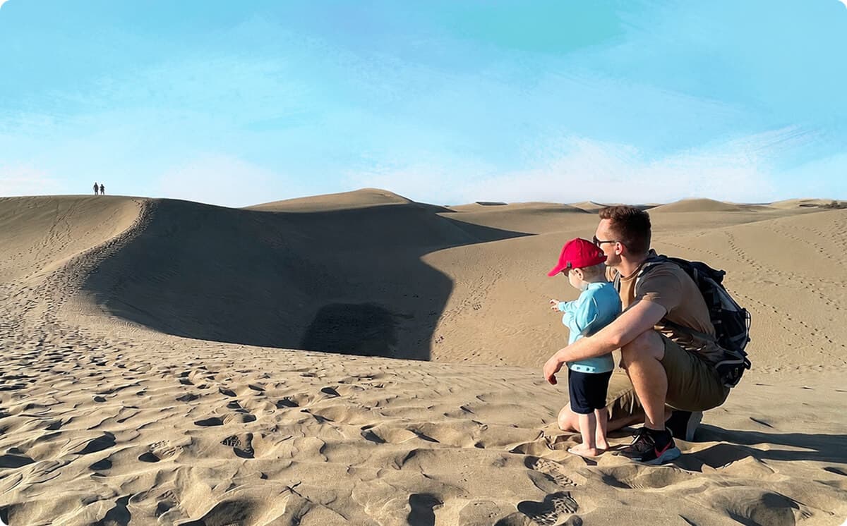 Lukas and his son Simon looking out over the sand dunes together